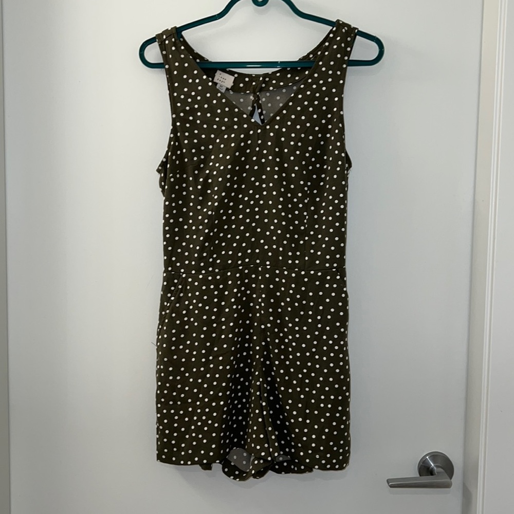 Olive green sleeveless romper with back cutout and white polka dots